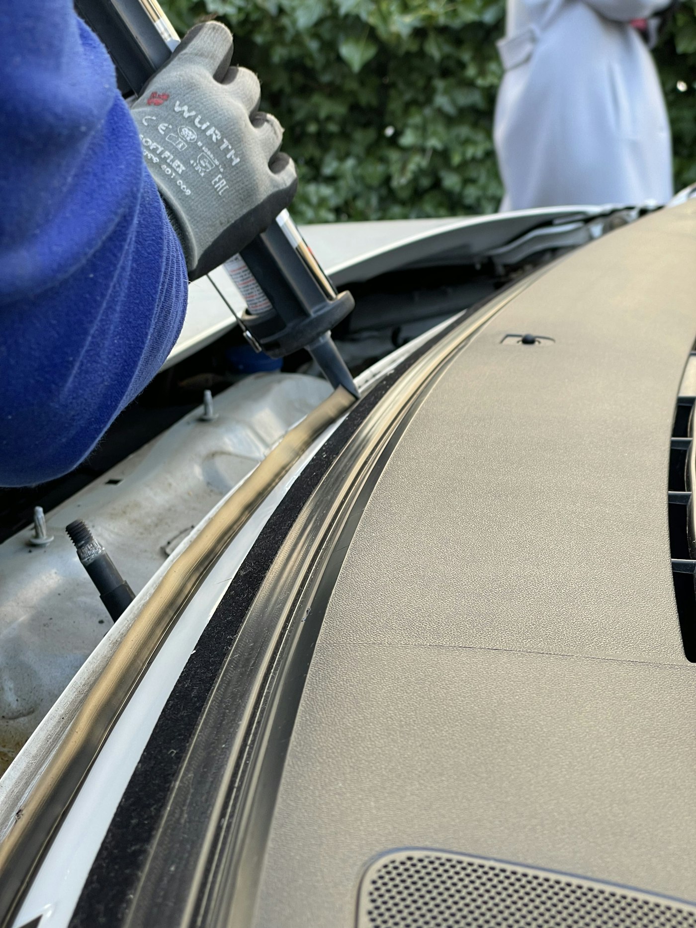 Auto glass technician working on a vehicle on location